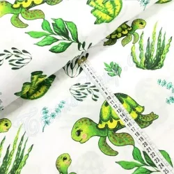 Cotton fabric printed with green seam turtles and plants | Wolf Fabrics
